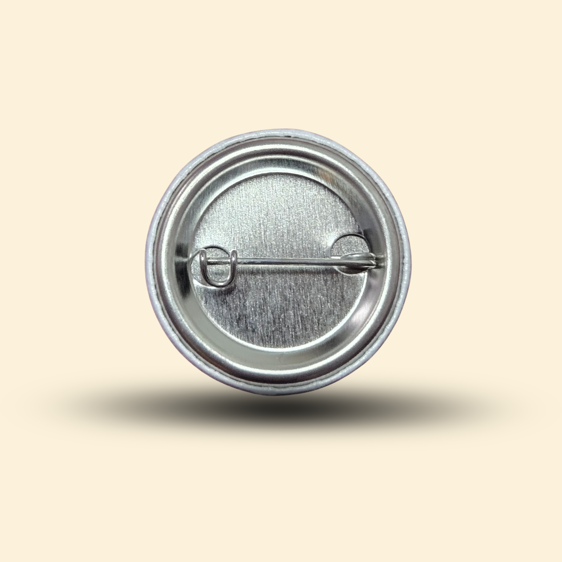 The back of a Mythic Manuscripts button pin.